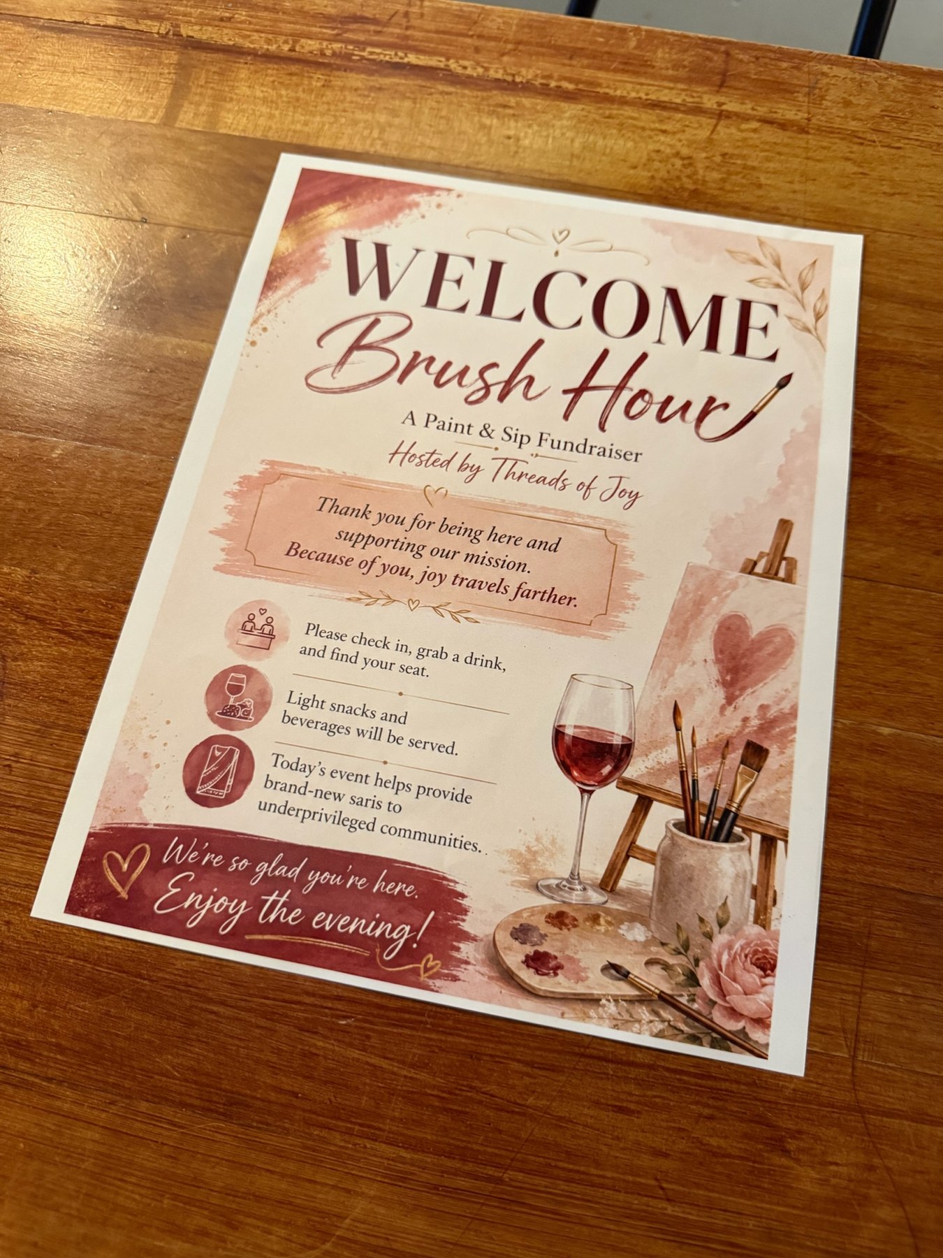 A printed Brush Hour welcome sheet sits on a wooden table.