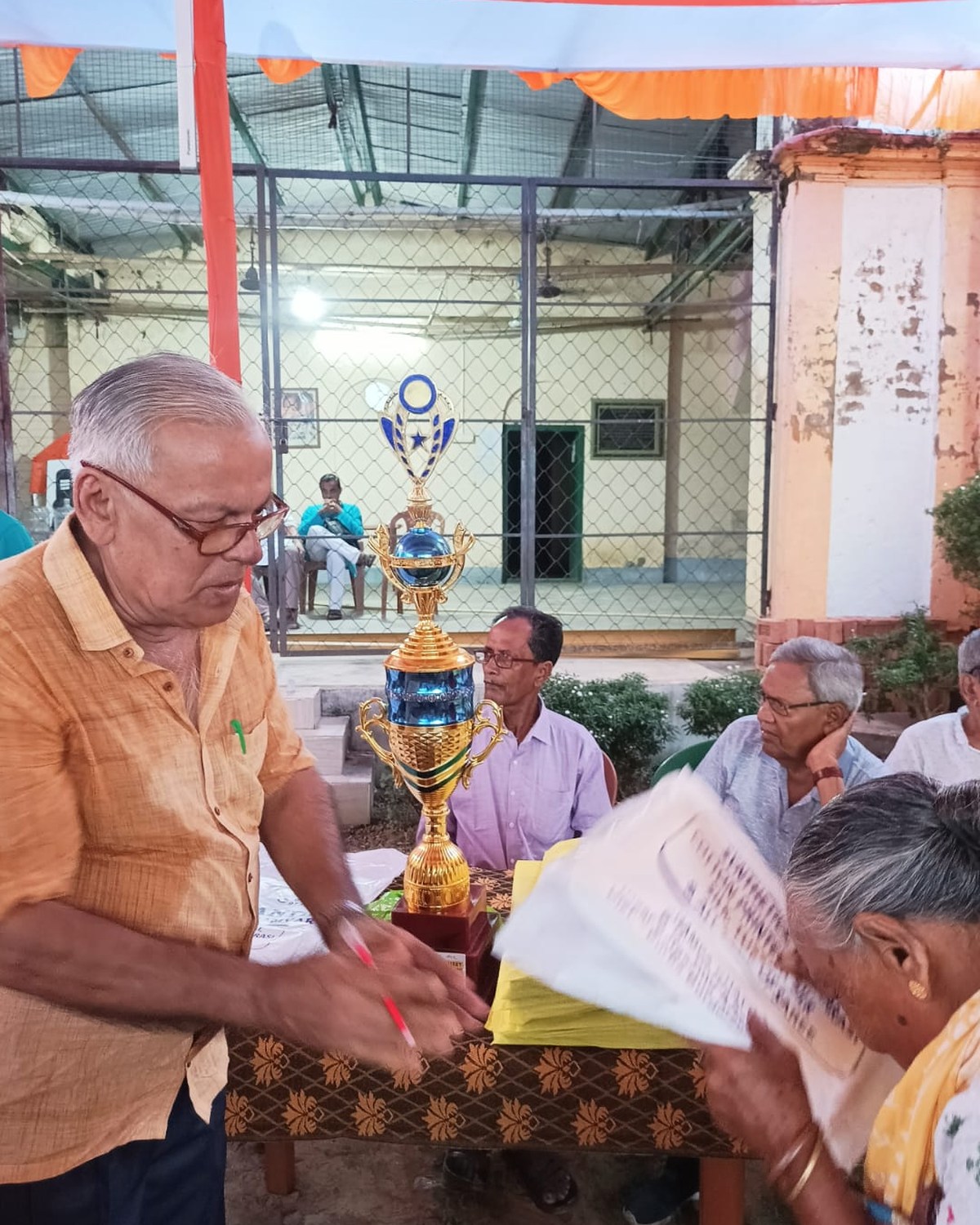 A community clothing distribution where a packaged garment is presented with care.